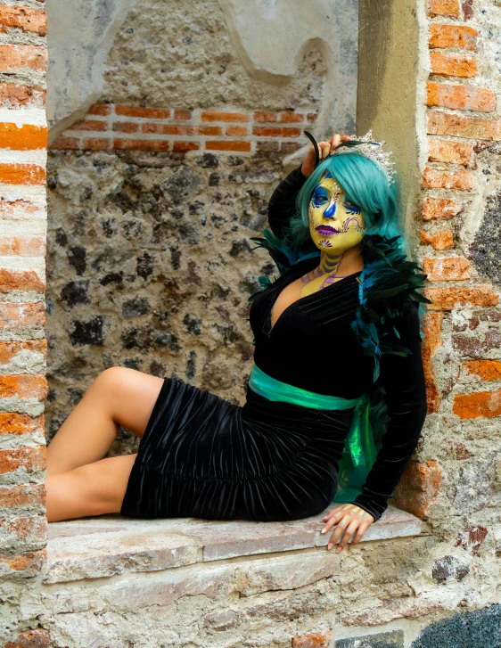 a woman in a costume sitting on a brick ledge