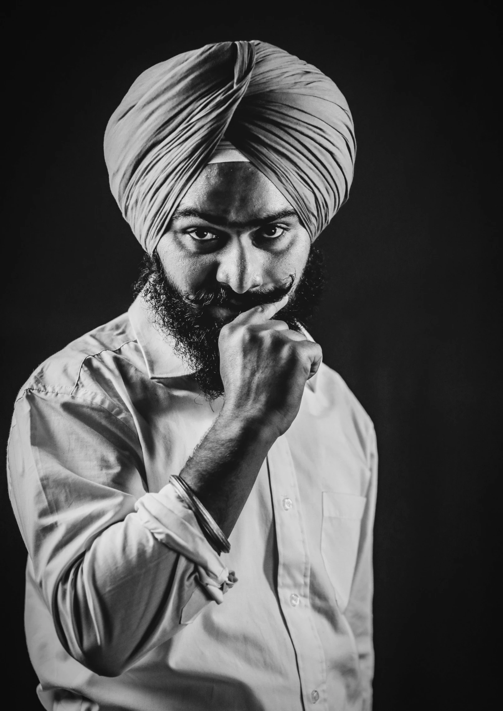 a man in a turban is posing for the camera