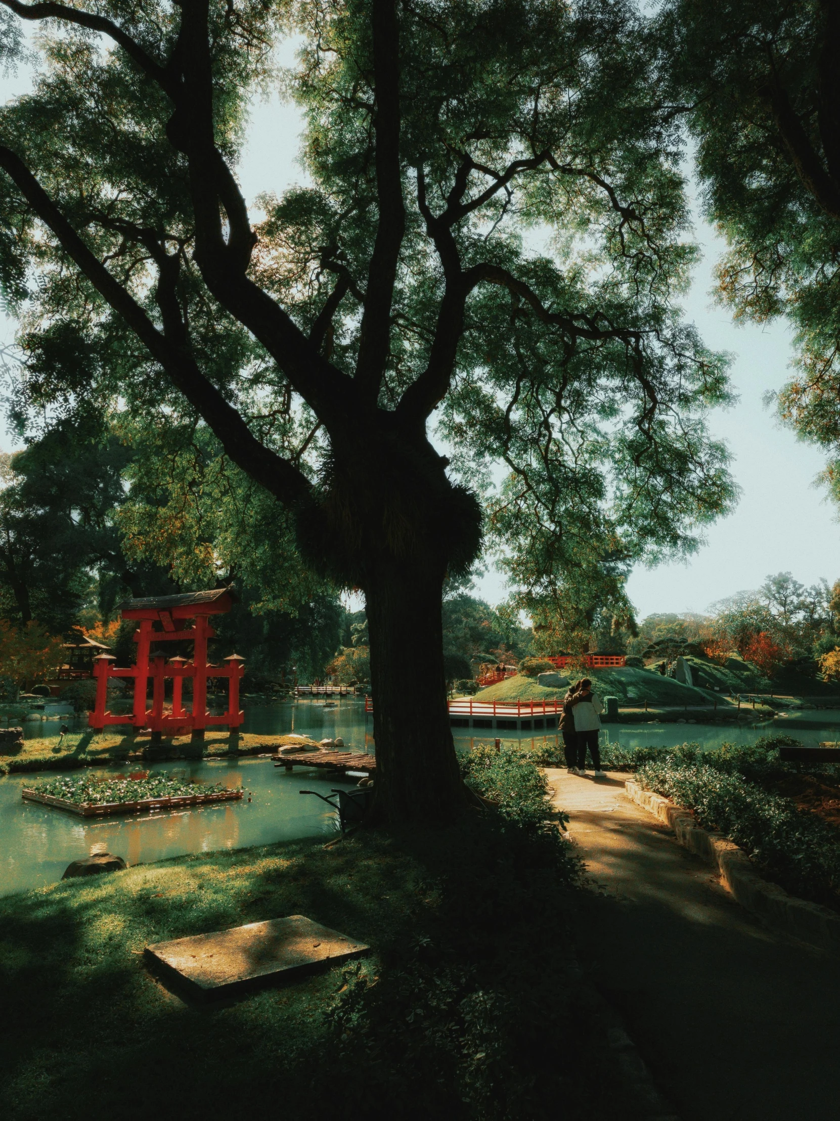 an old picture of some trees and a red structure