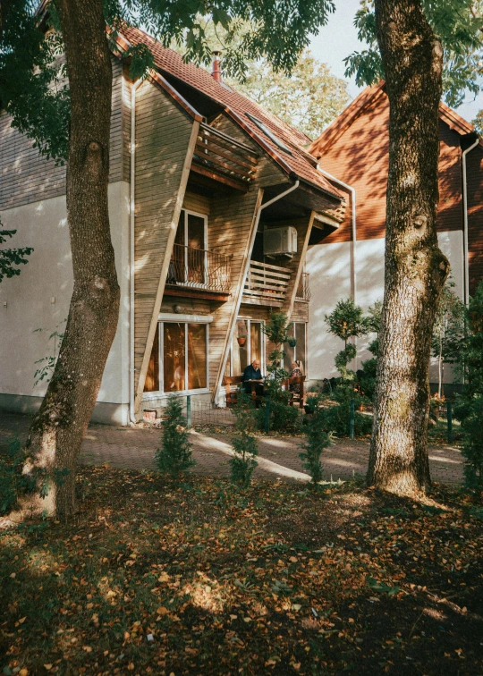 a big house with lots of windows next to some trees