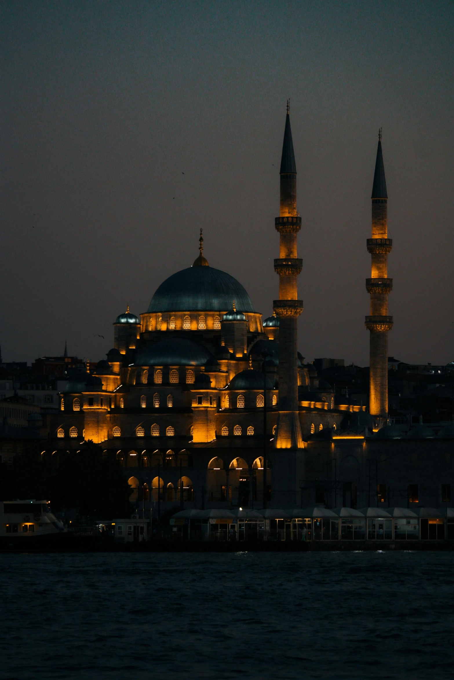 two blue domes lit up on a building in the dark