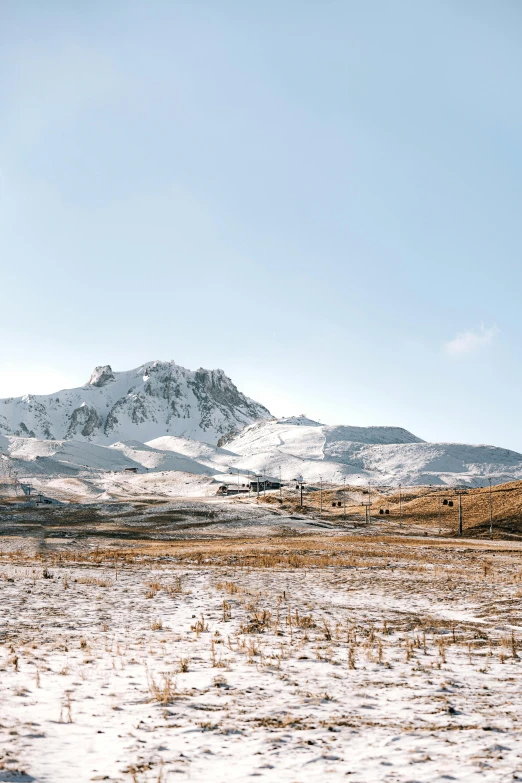 a snowy landscape with trees and hills in the distance