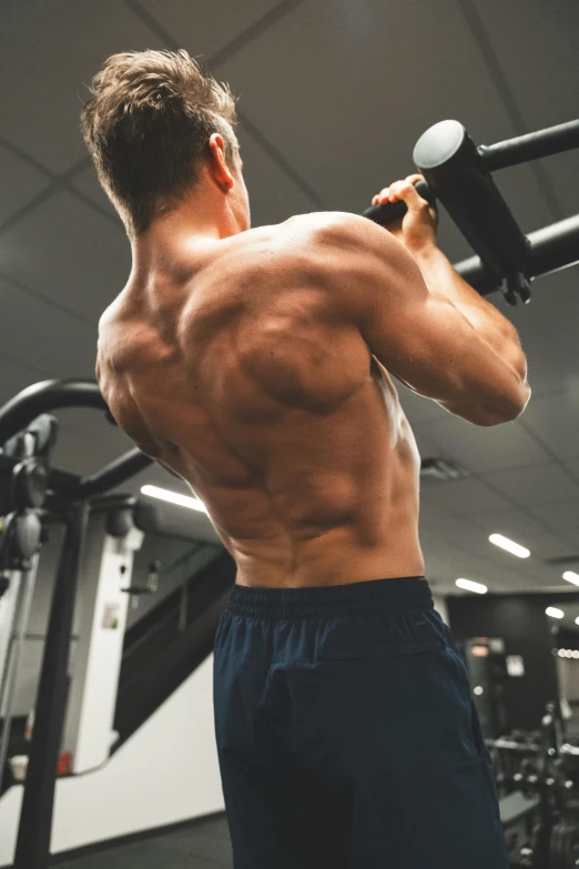 a man performing an exercise with weights in a gym