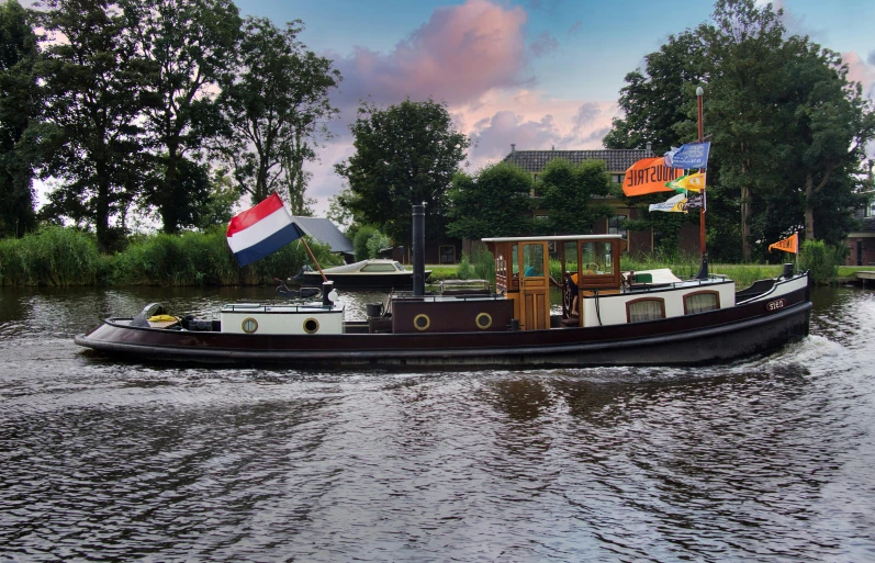 a boat traveling on top of water near trees