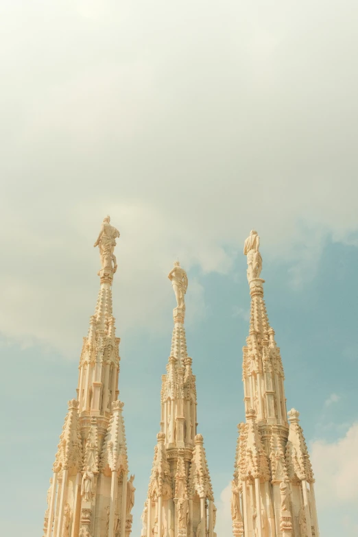 several white statues with sky in the background