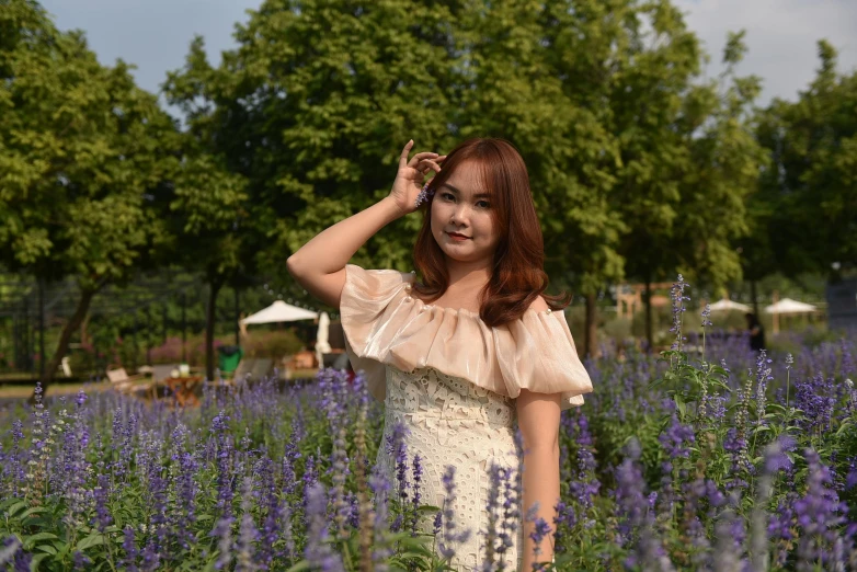 young woman in field of flowers making funny face