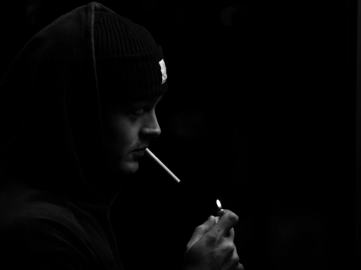 a black and white po of a man with cigarette