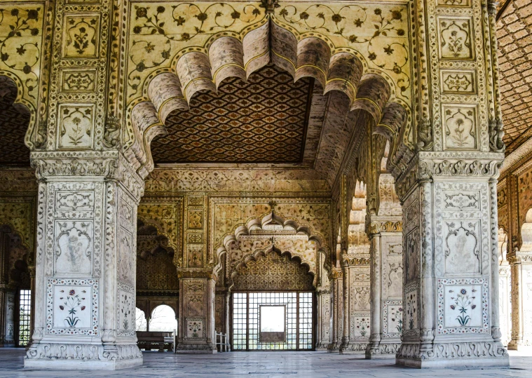 the inside view of an intricate building with columns and arches