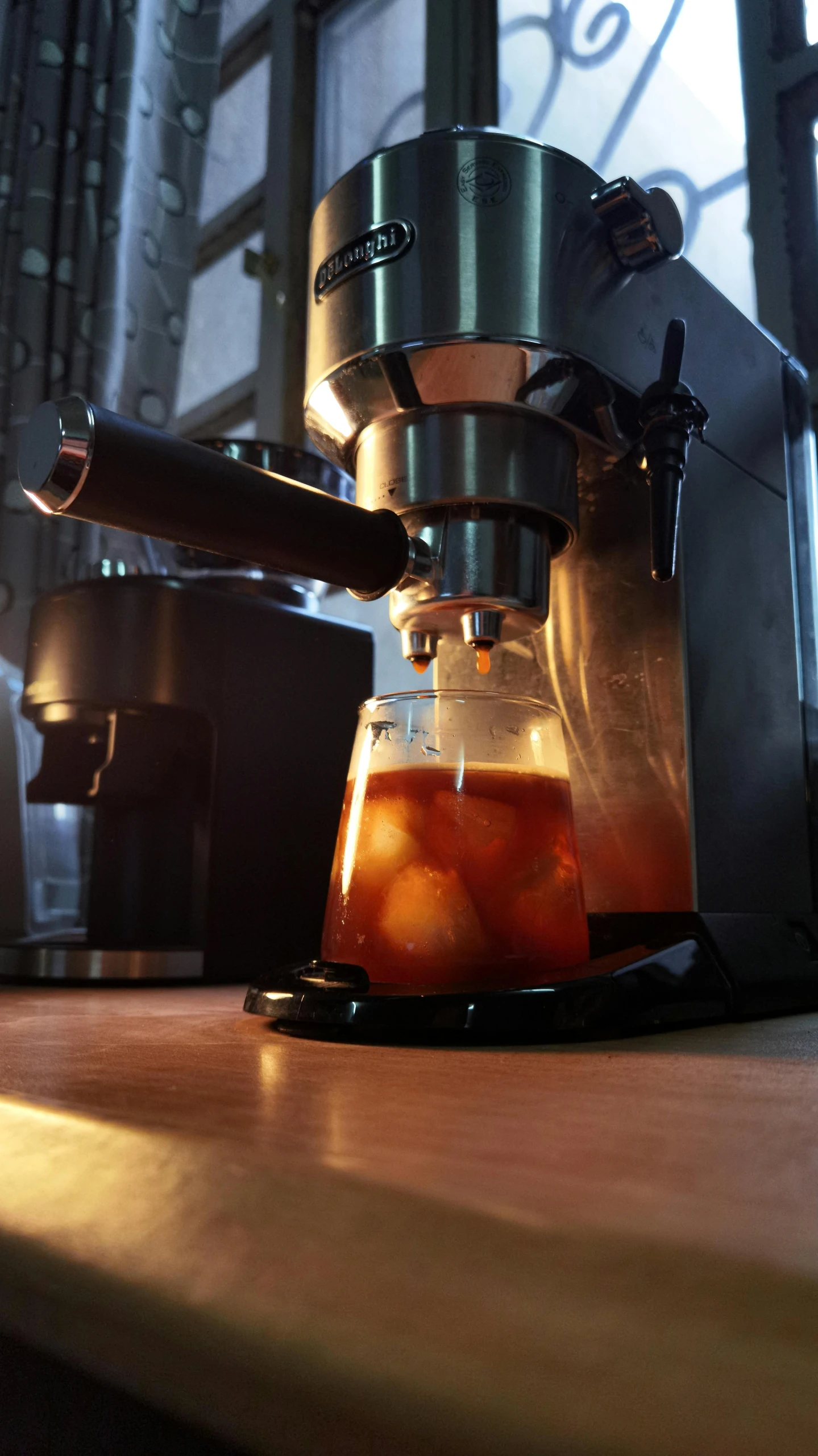 a coffee maker with liquid inside of it on top of a counter