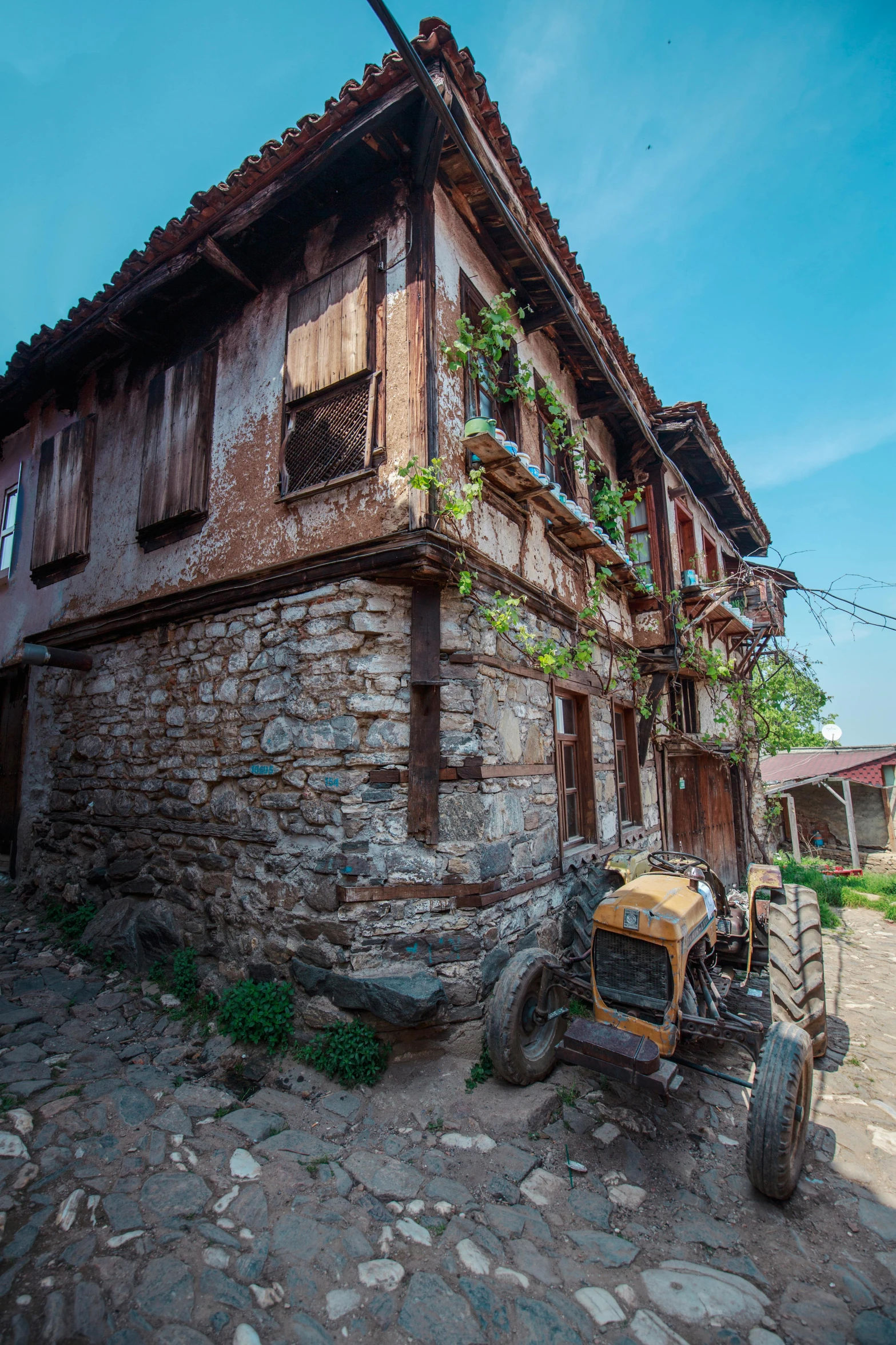 there is a tractor parked in front of a building