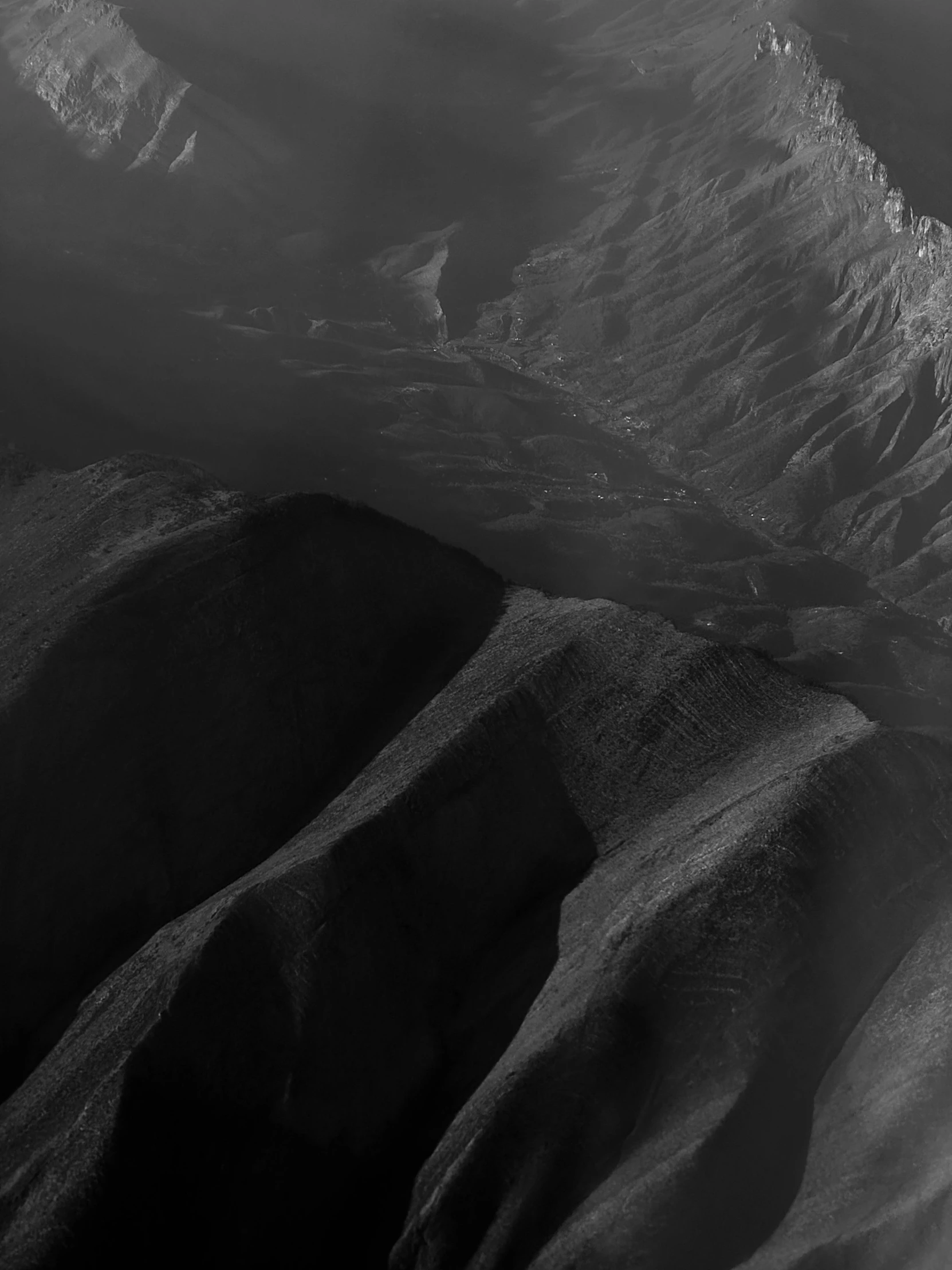 a black and white pograph of the top of mountains