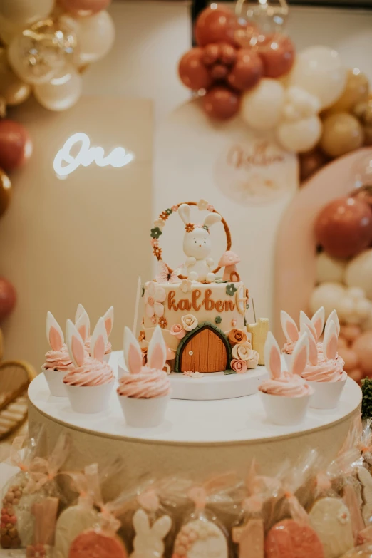 a cake on top of a round table filled with lots of candy