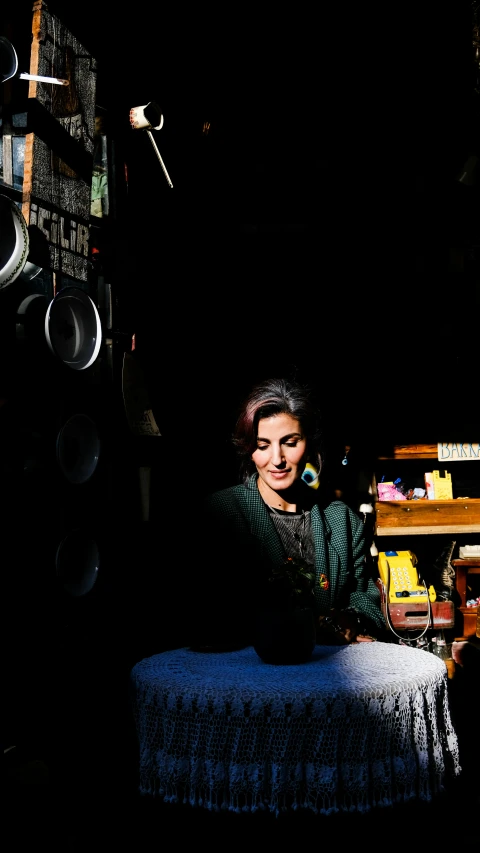 a woman sitting in her room on a stool