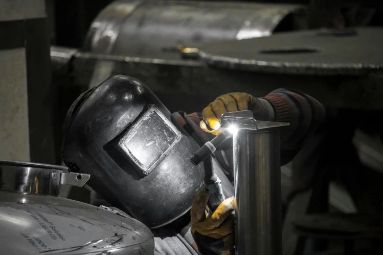 a person working with an object in the process of welding