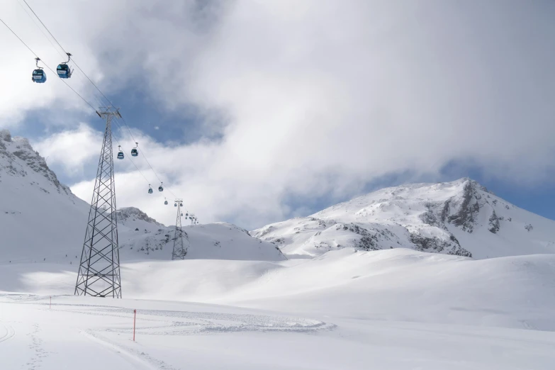 a lift going down a mountain with snow