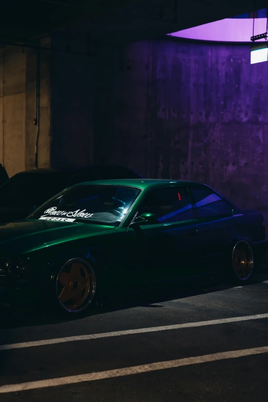 a car parked in front of a purple wall