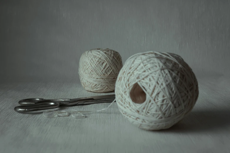 two balls of yarn with one ball hooked up