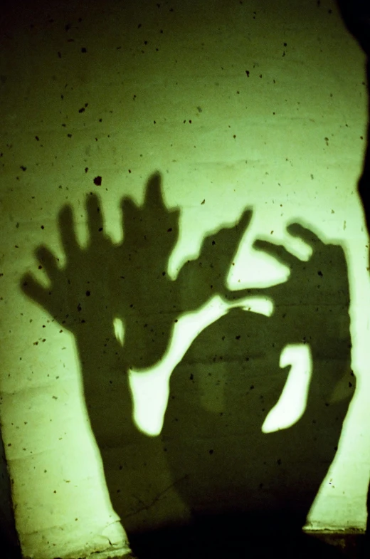 the shadow of a hand with an outstretched arm
