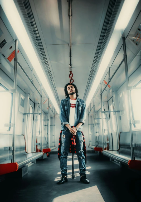 a man leaning up against a rail in a train