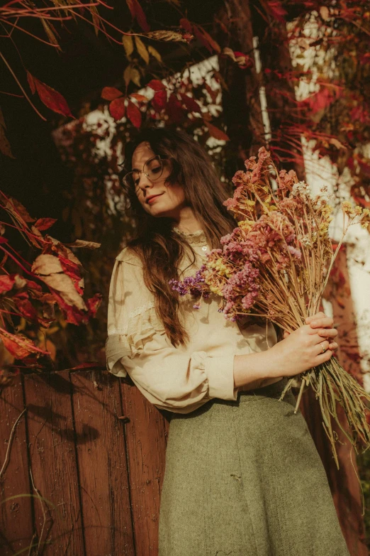 a woman standing with flowers in her hands