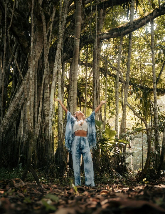 a woman in high heels standing in the forest