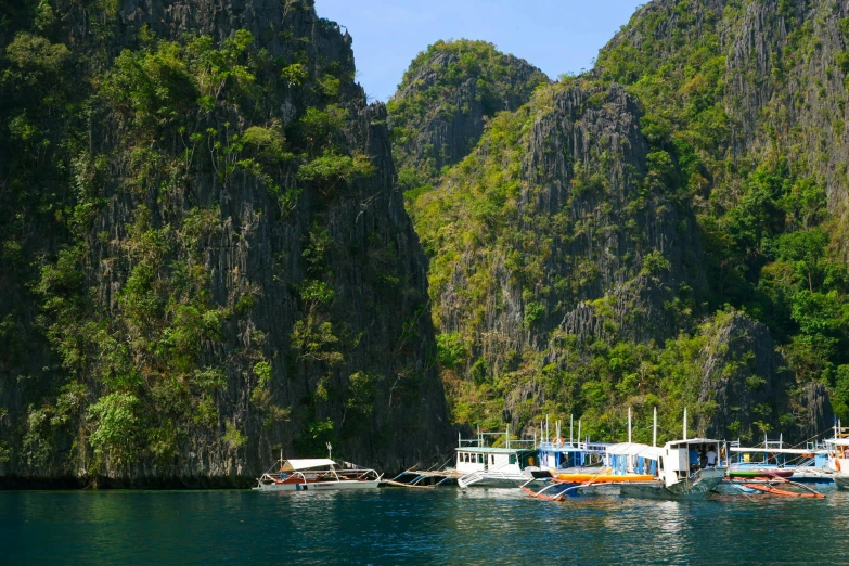 a number of small boats sitting on the water