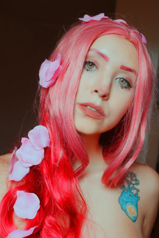 a pink haired girl with tattoos and flowers