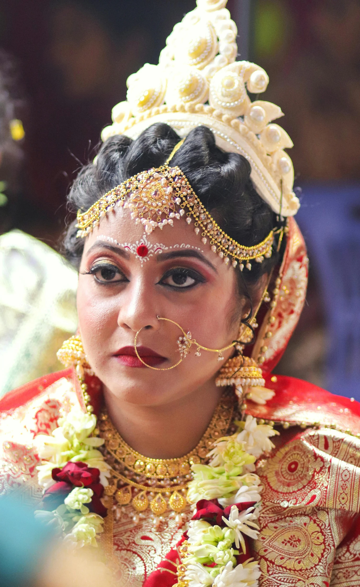 a close - up of a bride wearing gold and red