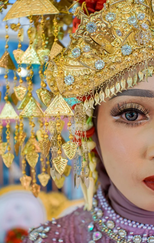 a woman with a gold headdress standing by a clock