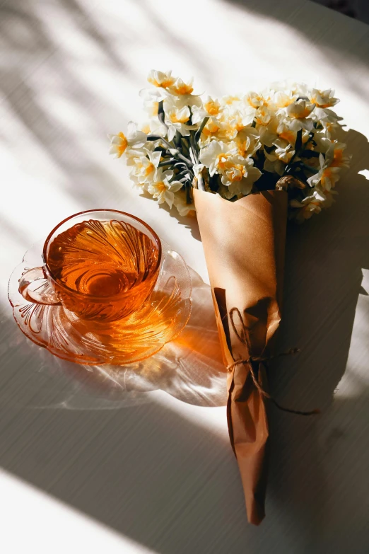 a bouquet of flowers next to a vase on a table