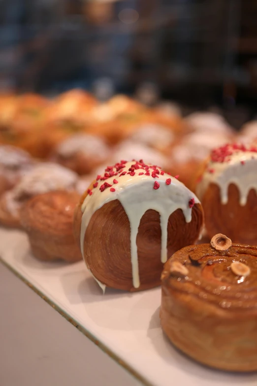 desserts in the shape of donuts with icing and nuts