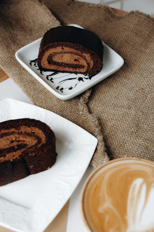 two pieces of chocolate cake sitting on a white plate