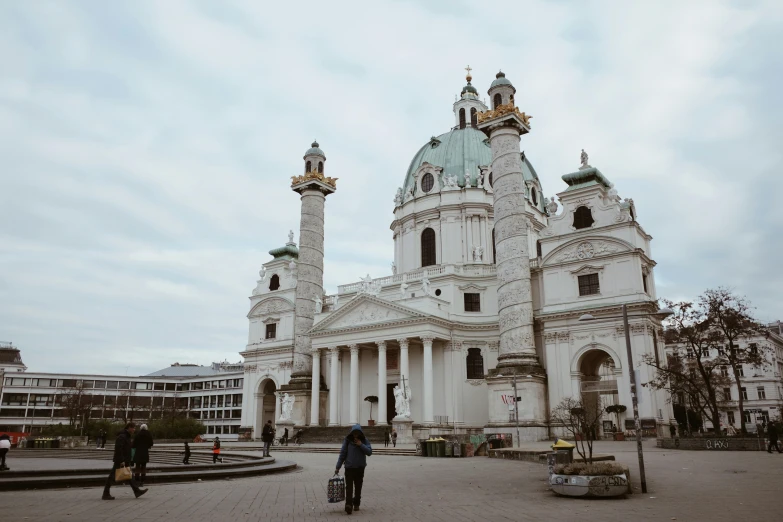 two tall, ornate towers sit behind an old building