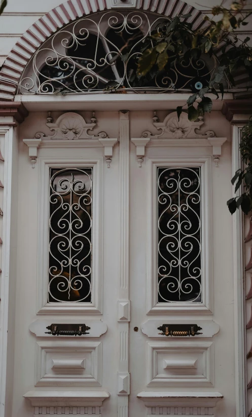 two doors in different sizes and designs on a building