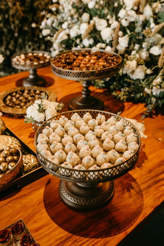 there are many desserts on the table in a fancy tray