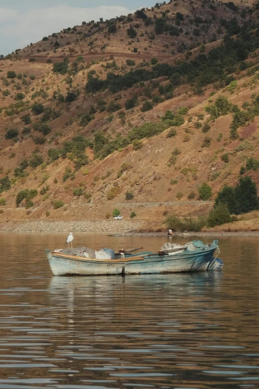 two boats on a river, one is broken