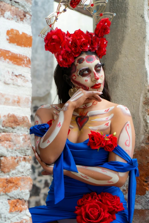 a woman dressed as a skeleton with red roses around her neck
