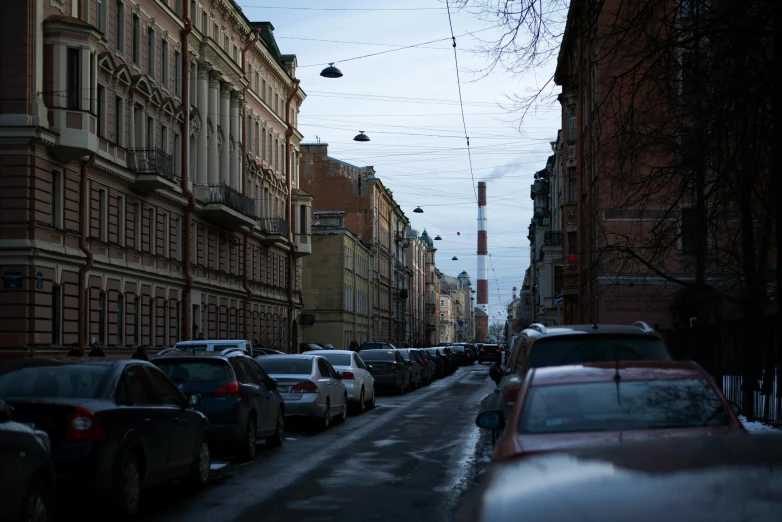 a snowy street lined with tall buildings and lots of traffic