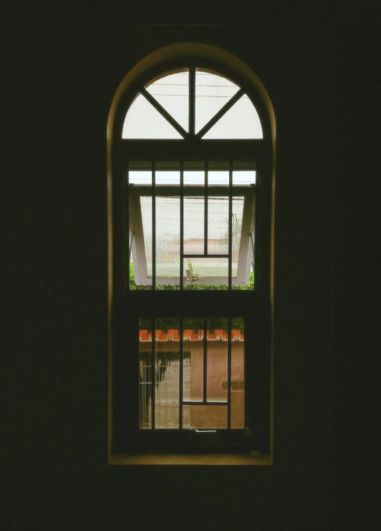 an open window with a wrought iron frame on it