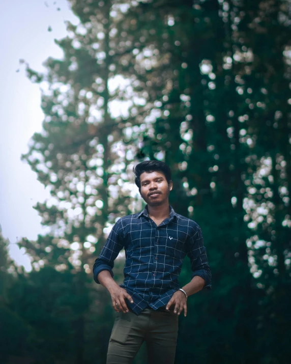 a man is smiling next to trees