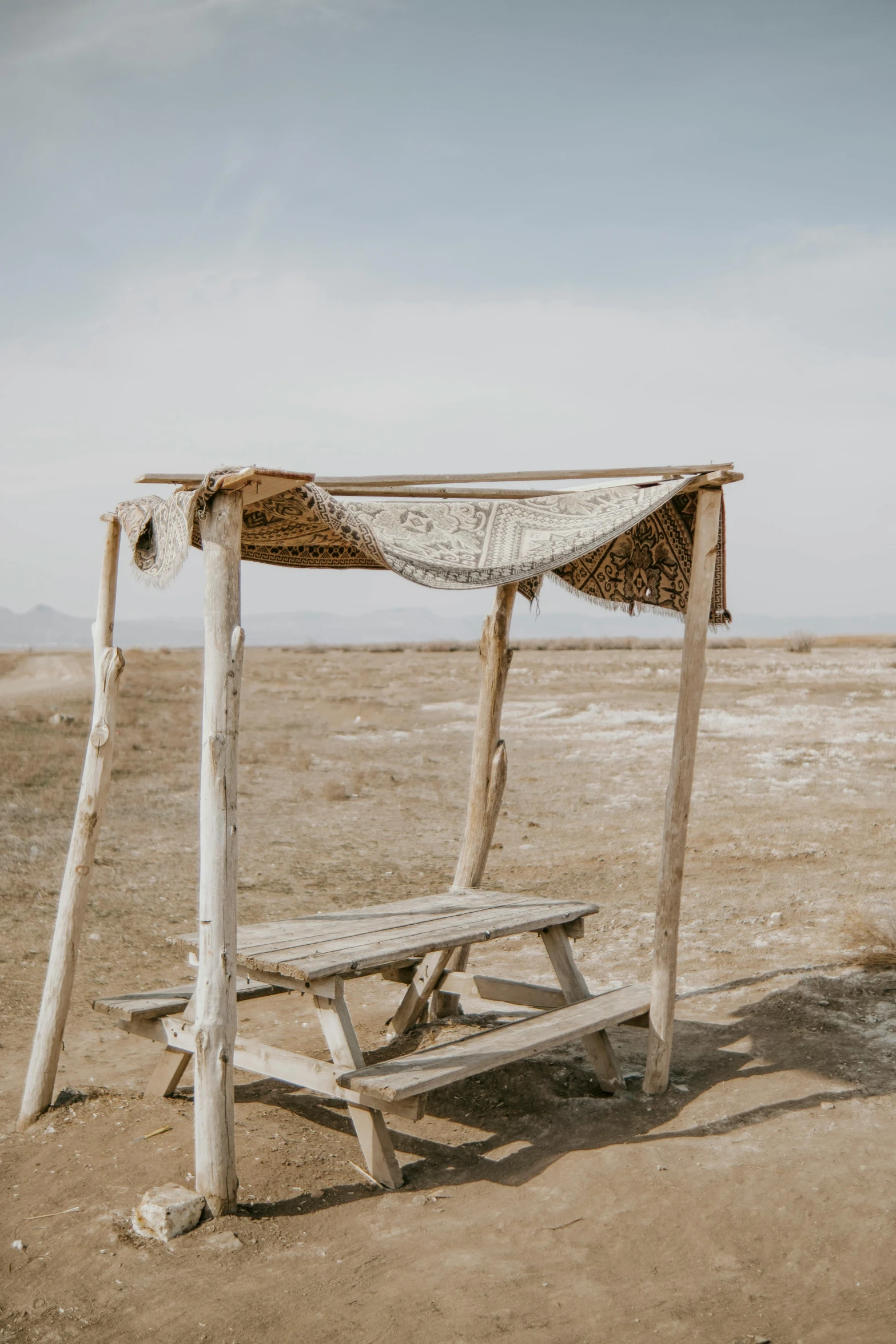 the old wooden bench is covered with an old lace on it