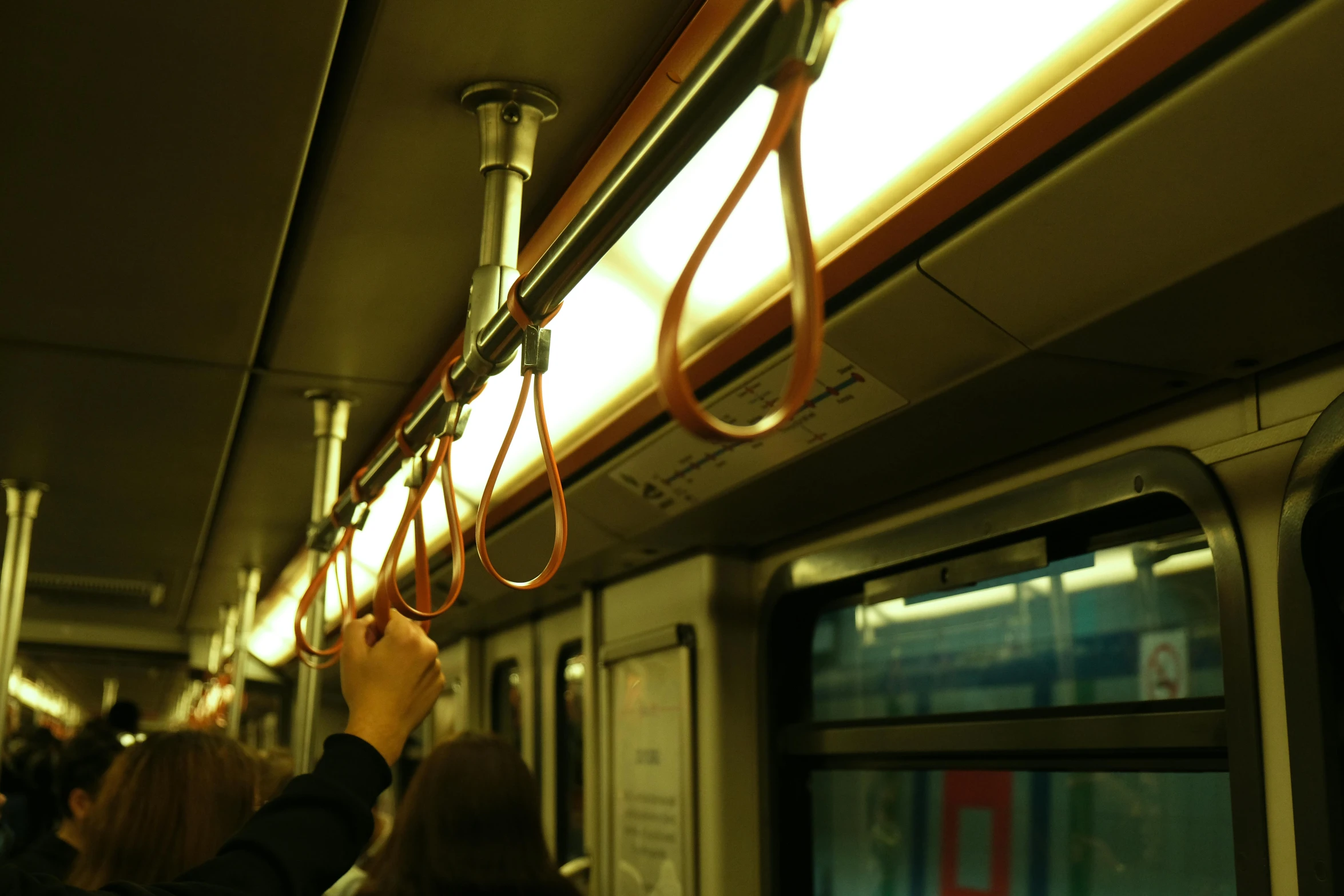 people hanging onto a subway line by wires