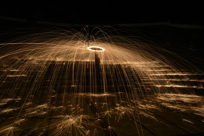 a man holding a skateboard and making a light show