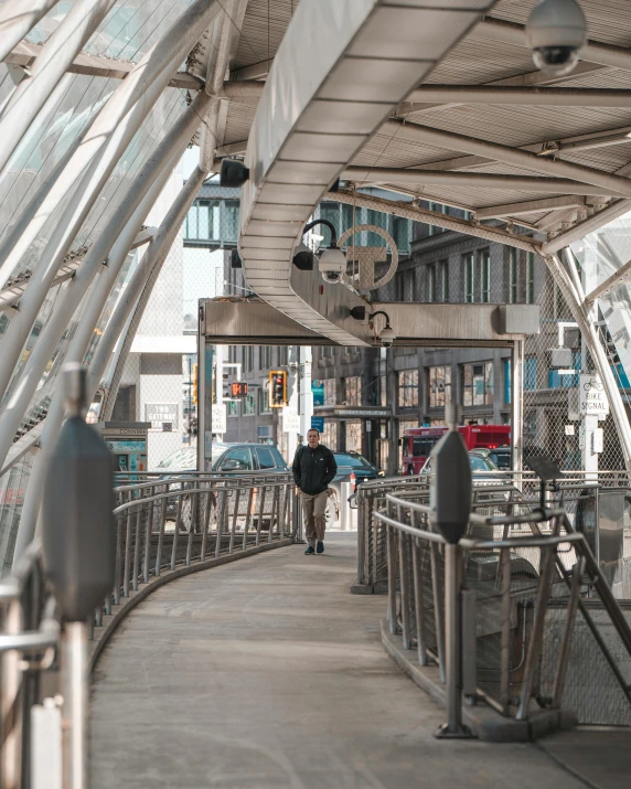 a couple of people walk across a walkway