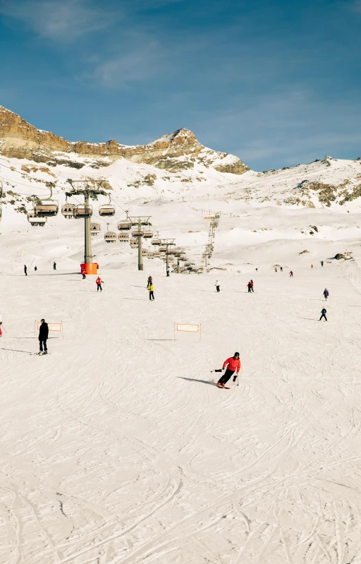 snow covered ski slope with several people skiing in the background