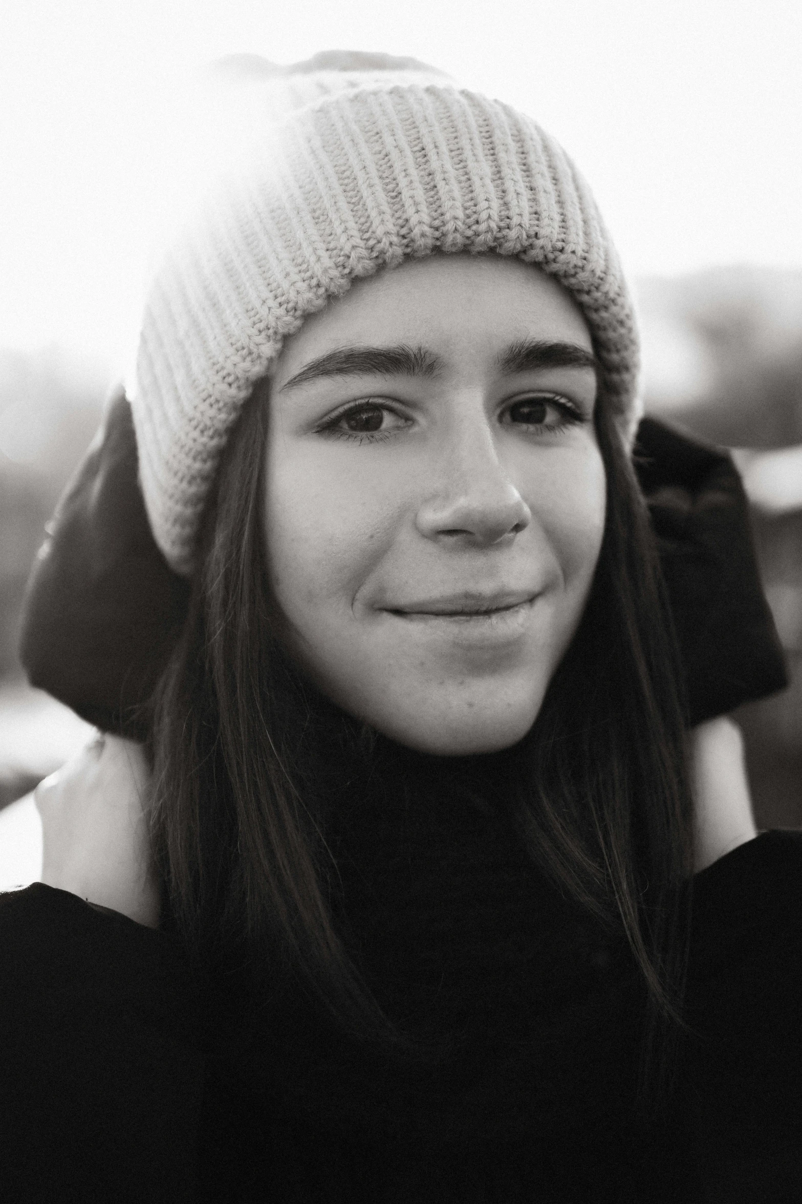 a black and white po of a woman wearing a hat