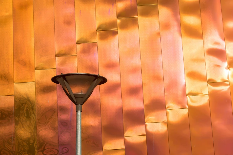 a lamp in front of a wood paneled wall