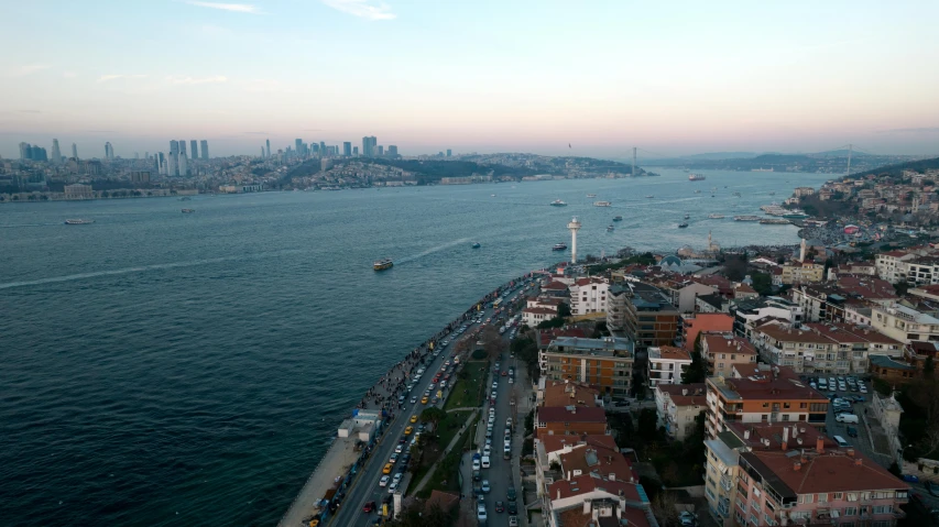 an aerial view of a city with a body of water in front