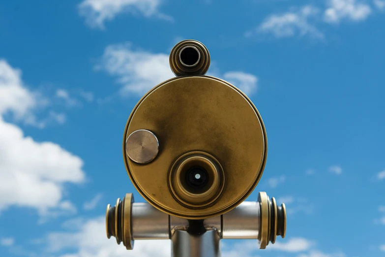 an old style binoculars looks into the sky