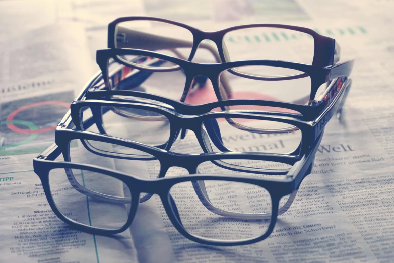 a pair of glasses on top of newspaper